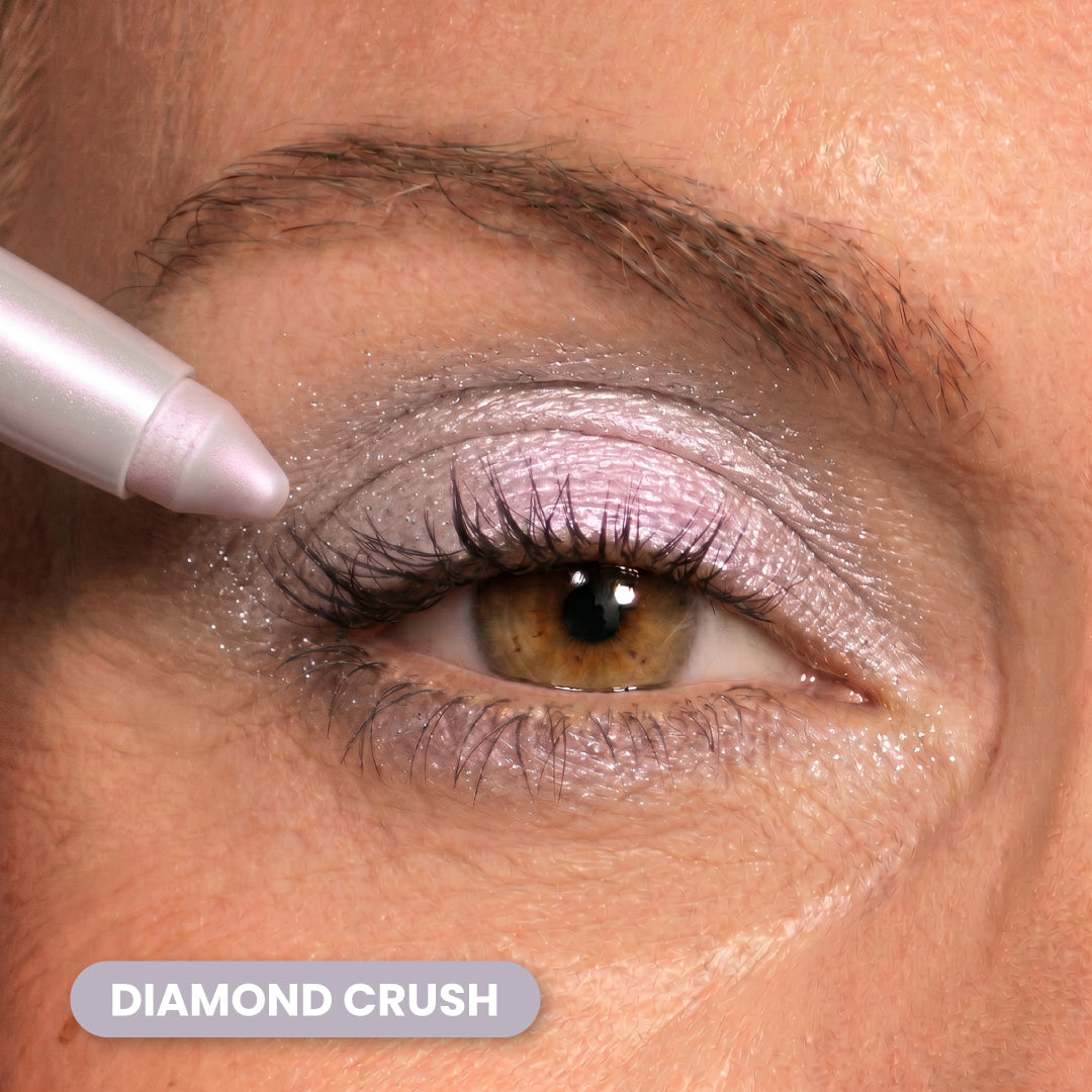 A close-up of an eye with shimmery, silver eyeshadow being applied with a pencil. The label Diamond Crush appears at the bottom left.
