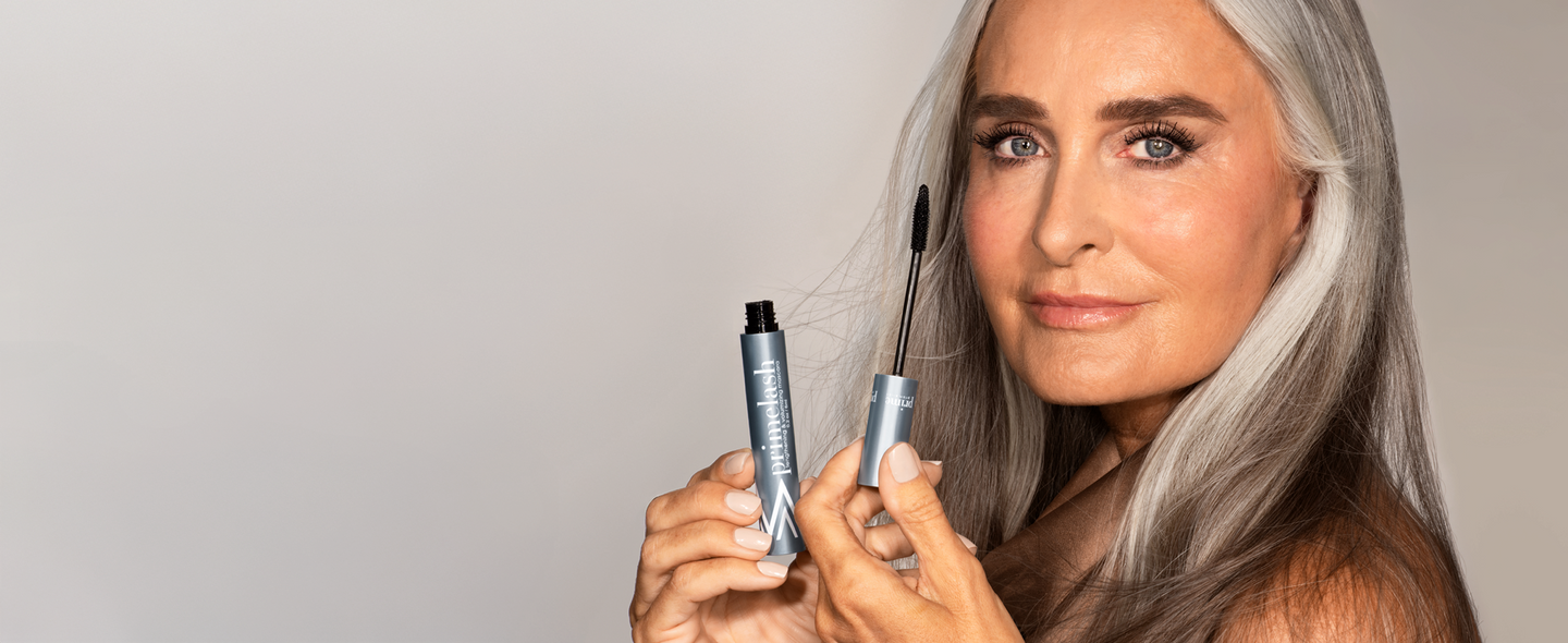 Woman applying pro-age mascara