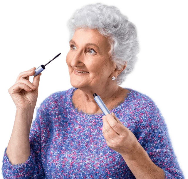 Mature woman applying PrimeLash Mascara to upper lashes.
