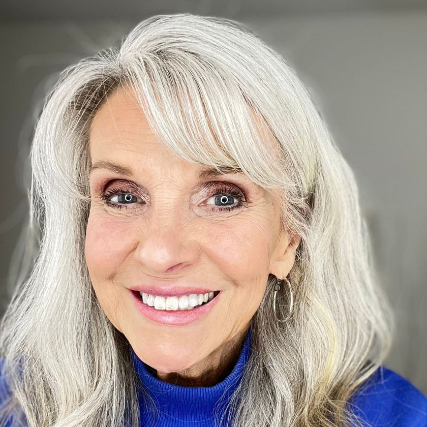 Mature woman with grey hair, 65-year-old PrimEyes Eye Brightener customer.